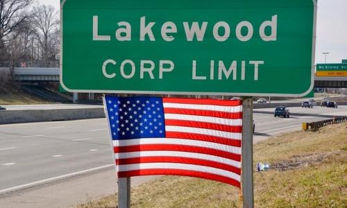 Lakewood Corp Limit Highway Sign and American Flag