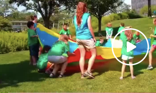 Summer campers and counselors playing outside