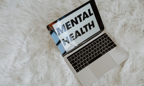 Open laptop displaying the words mental health