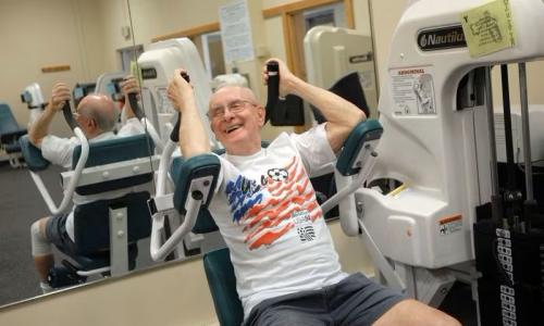 Senior citizen using a machine to workout at the YMCA