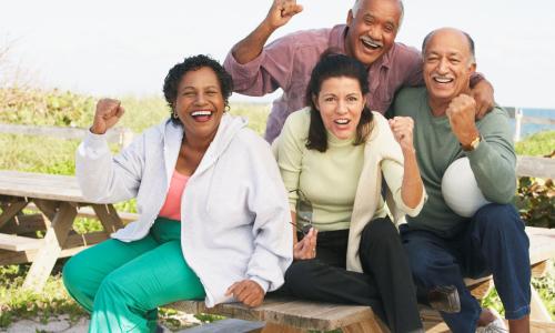 Group of middle aged men and women cheering