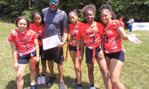 Girls on the Turf team smile with coach