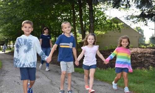 Children holding hands and smiling together