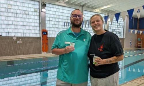 West Park YMCA aquatic director Jim Mannion (left) and Mary Smink Worthy, of Lorain, pose together holding apple juice boxes at the West Park YMCA after Smink Worthy donated $500 to fund swim lessons in memory of her friend, Ayesha "Juice" Kadi, 20, who drowned at Lakeview Park beach in June.