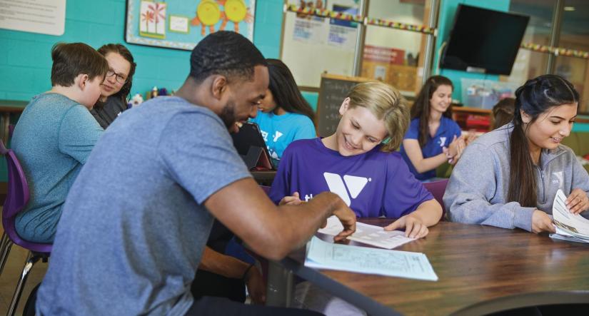 Y Staff member working with child during afterschool program