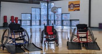 3 wheelchairs on court showing adaptive equipment at the ymca