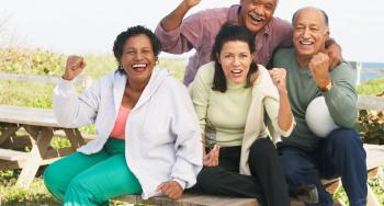 Group of middle aged men and women cheering