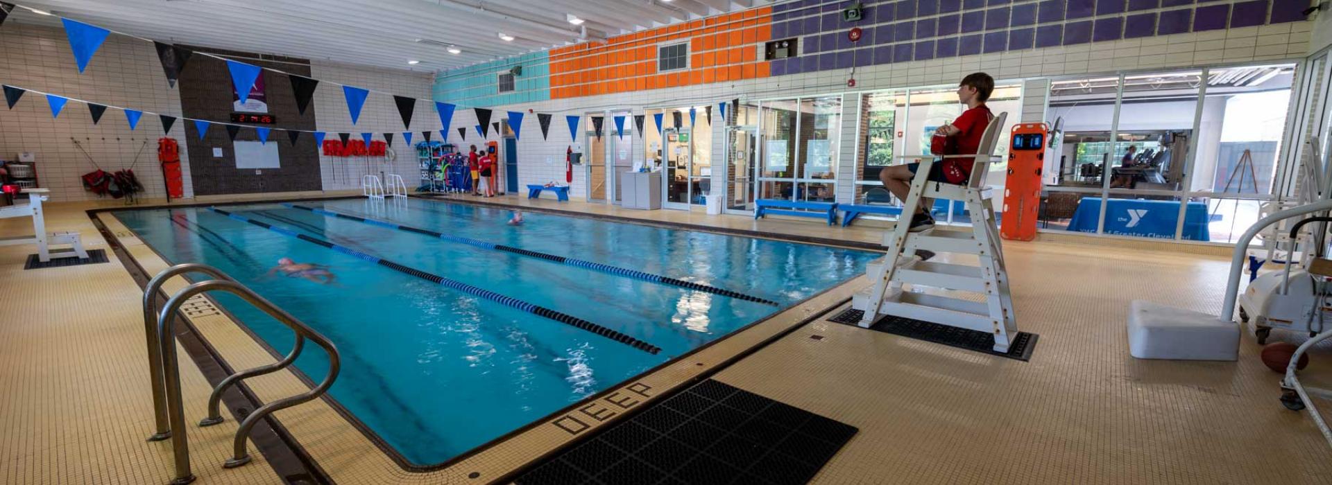 West Shore pool deck. Image shows lifeguard watching over swim lanes.