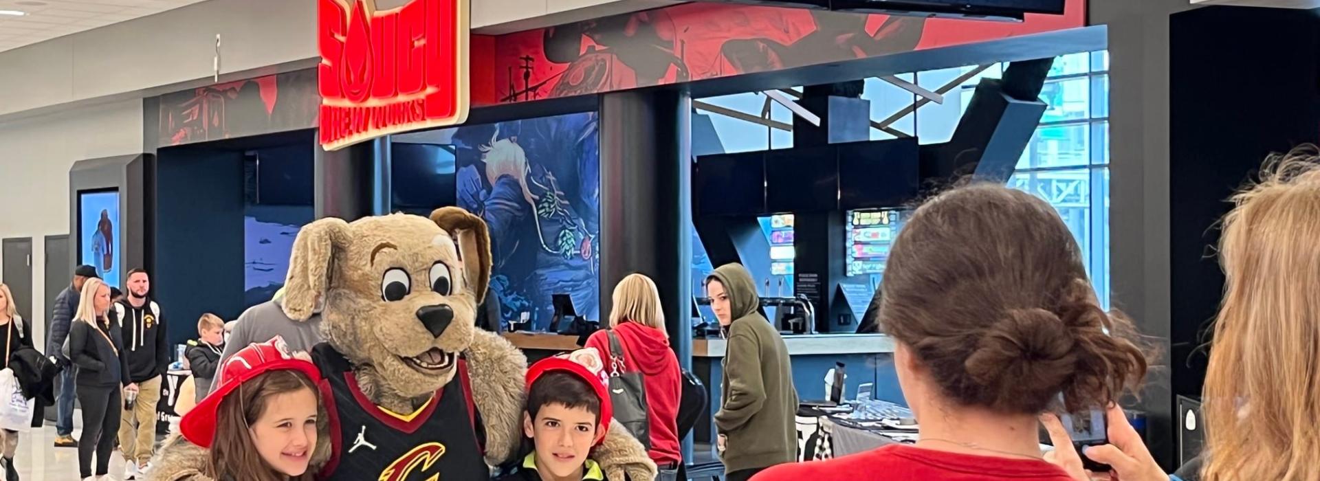 Kids taking a photo with the Cavs mascot